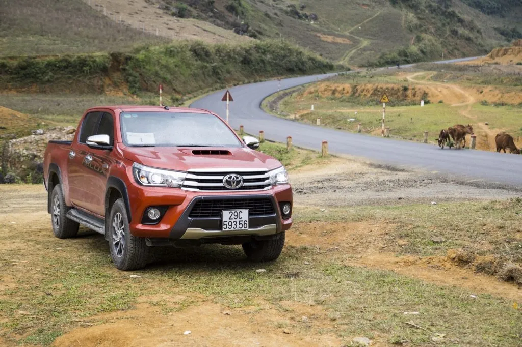 Red Toyota Hilux on a gravel road
